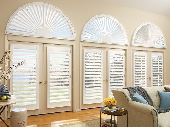 Shutters tilted open on three French doors in living room